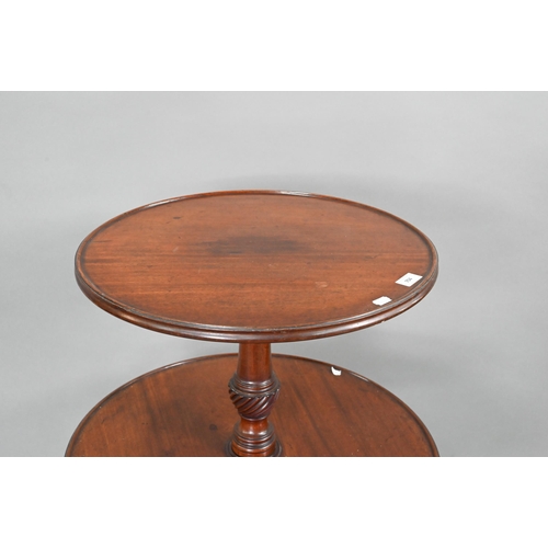 704 - A Victorian mahogany two graduated dumb waiter, on tripod base, 60 cm dia. x 98 cm h