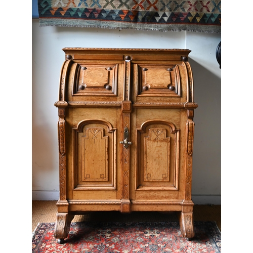 707 - An antique American Wells Fargo 'Wooton' style desk, golden oak, the hinged upper panel over a pair ... 