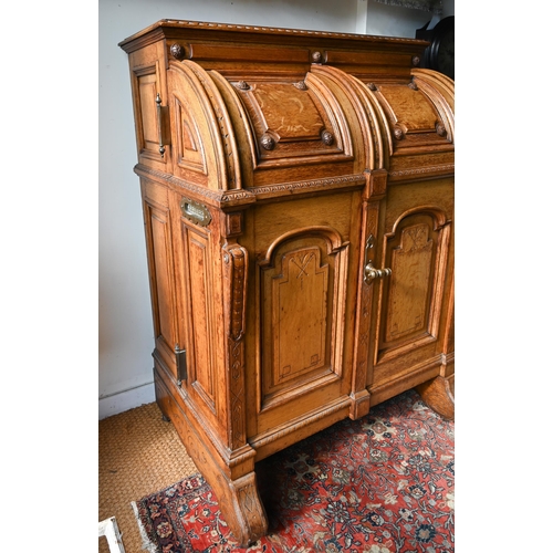 707 - An antique American Wells Fargo 'Wooton' style desk, golden oak, the hinged upper panel over a pair ... 