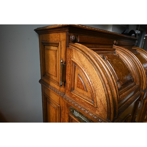 707 - An antique American Wells Fargo 'Wooton' style desk, golden oak, the hinged upper panel over a pair ... 