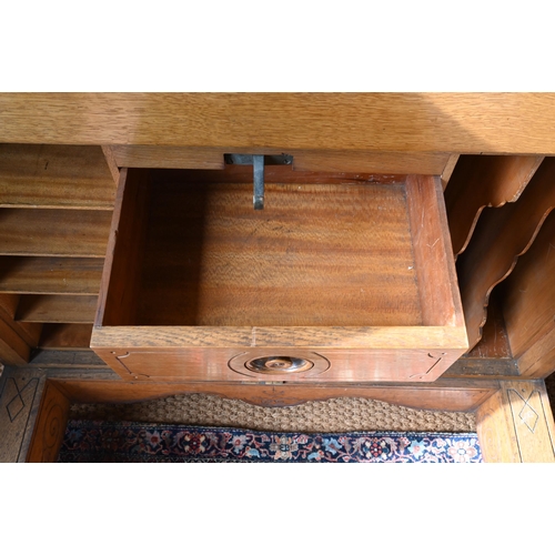 707 - An antique American Wells Fargo 'Wooton' style desk, golden oak, the hinged upper panel over a pair ... 