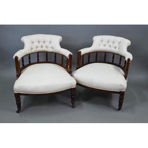 711 - A companion pair of Edwardian walnut bow framed buttoned backed salon chairs, raised on turned front... 