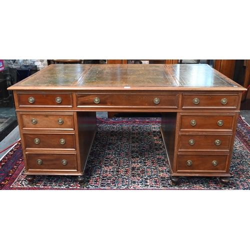 714 - A traditional red walnut twin pedestal partners desk, the triple green leather panelled top over an ... 