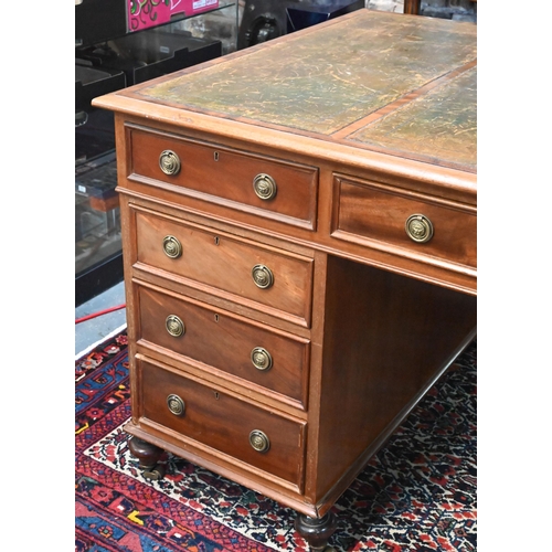 714 - A traditional red walnut twin pedestal partners desk, the triple green leather panelled top over an ... 