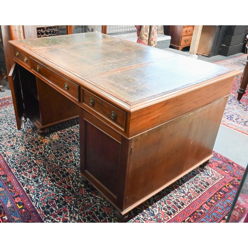 714 - A traditional red walnut twin pedestal partners desk, the triple green leather panelled top over an ... 