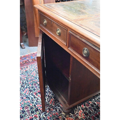 714 - A traditional red walnut twin pedestal partners desk, the triple green leather panelled top over an ... 