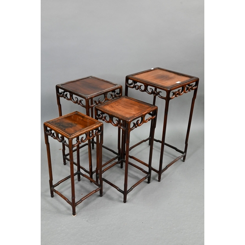 716 - A graduated set of four Chinese stacking hardwood occasional tables, with pierce friezes, circa 1900... 