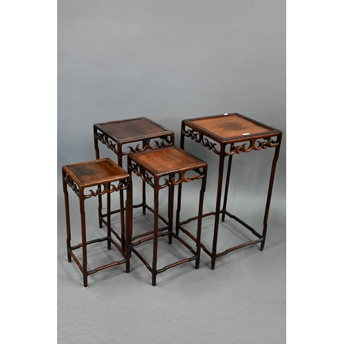 716 - A graduated set of four Chinese stacking hardwood occasional tables, with pierce friezes, circa 1900... 