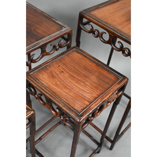 716 - A graduated set of four Chinese stacking hardwood occasional tables, with pierce friezes, circa 1900... 