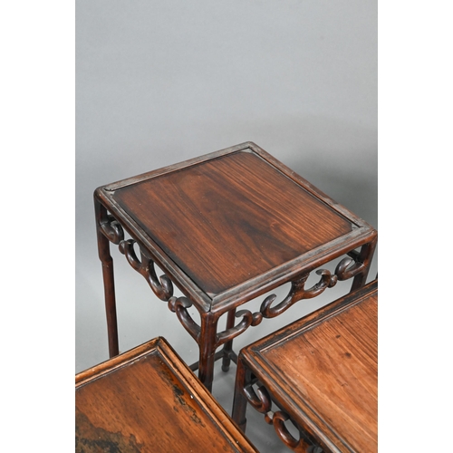 716 - A graduated set of four Chinese stacking hardwood occasional tables, with pierce friezes, circa 1900... 