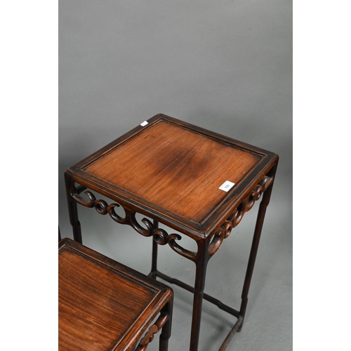 716 - A graduated set of four Chinese stacking hardwood occasional tables, with pierce friezes, circa 1900... 