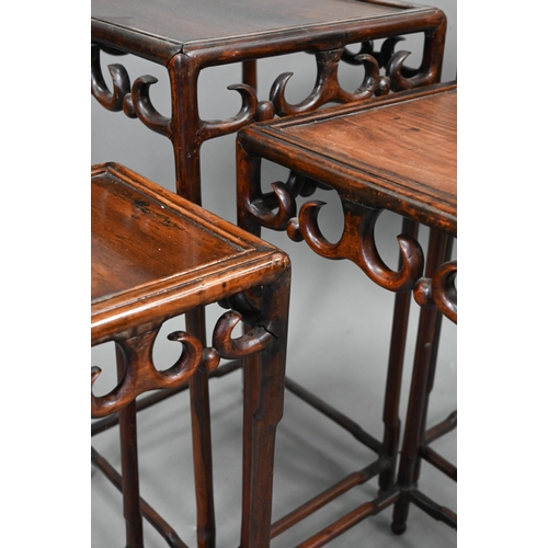 716 - A graduated set of four Chinese stacking hardwood occasional tables, with pierce friezes, circa 1900... 