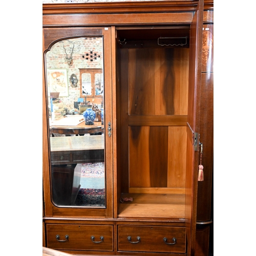 717 - AMENDED ESTIMATE An Edwardian Sheraton Revival inlaid satin walnut wardrobe, the twin mirrored doors... 