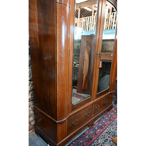 717 - AMENDED ESTIMATE An Edwardian Sheraton Revival inlaid satin walnut wardrobe, the twin mirrored doors... 