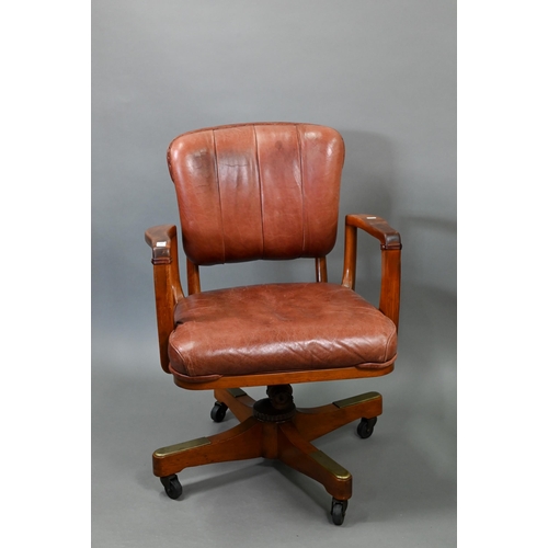 718 - A vintage American brown leather upholstered overstuffed swivel seat office chair by Sikes, on brass... 