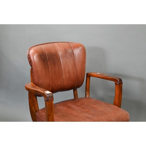 718 - A vintage American brown leather upholstered overstuffed swivel seat office chair by Sikes, on brass... 