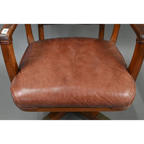 718 - A vintage American brown leather upholstered overstuffed swivel seat office chair by Sikes, on brass... 