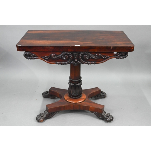 720 - A Regency rosewood card table, the fold over rotating top enclosing a blue baize lined surface, over... 