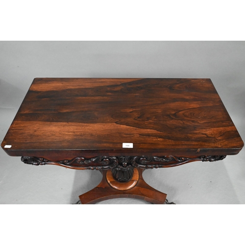 720 - A Regency rosewood card table, the fold over rotating top enclosing a blue baize lined surface, over... 