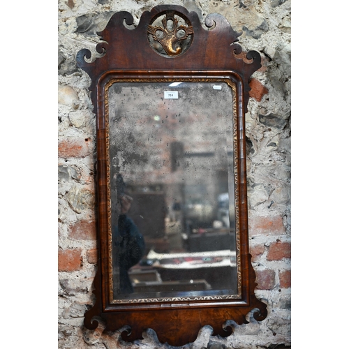 724 - An antique parcel gilt walnut fret cut mirror with distressed plate, 52 cm w x 94 cm h