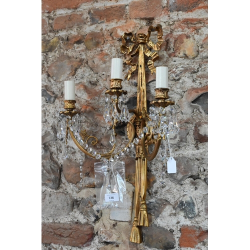 726 - A pair of Regency style ribbon and swag triple arm gilt metal wall sconces, crystal strung, 60 cm h ... 