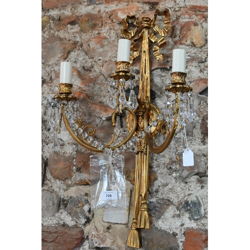 726 - A pair of Regency style ribbon and swag triple arm gilt metal wall sconces, crystal strung, 60 cm h ... 