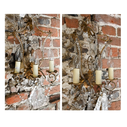 727 - A pair of gilt metal and crystal decorated pagoda style triple arm wall sconces, 60 cm h (2)