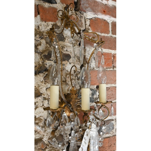 727 - A pair of gilt metal and crystal decorated pagoda style triple arm wall sconces, 60 cm h (2)