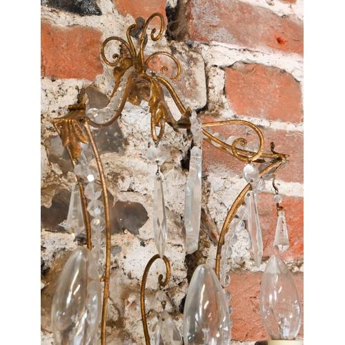 727 - A pair of gilt metal and crystal decorated pagoda style triple arm wall sconces, 60 cm h (2)