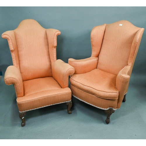 728 - Two similar hump wing-back armchairs with orange upholstery, raised on carved and cabriole front leg... 