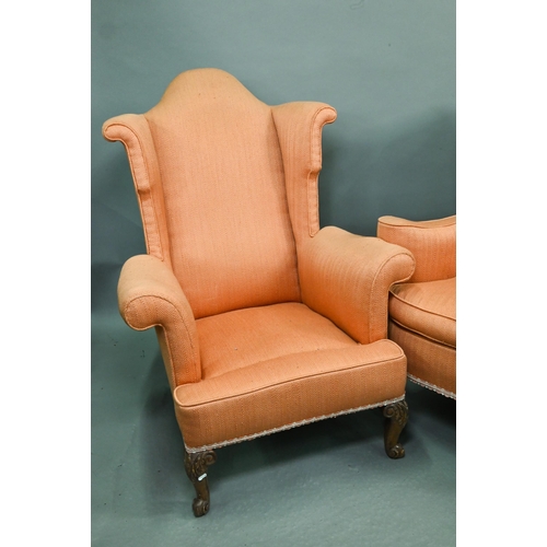 728 - Two similar hump wing-back armchairs with orange upholstery, raised on carved and cabriole front leg... 