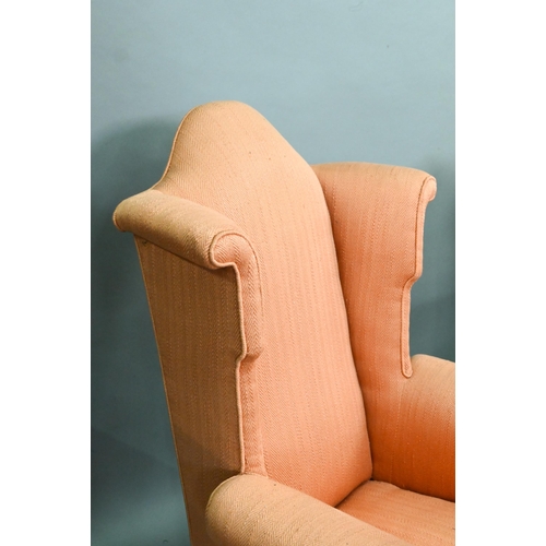 728 - Two similar hump wing-back armchairs with orange upholstery, raised on carved and cabriole front leg... 