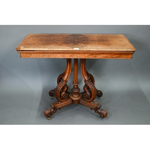 729 - A Victorian figured walnut card table, the rectangular fold over top enclosing a baize lined interio... 