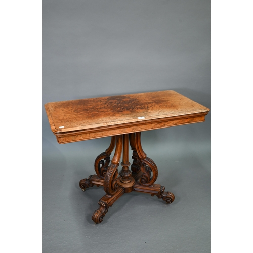 729 - A Victorian figured walnut card table, the rectangular fold over top enclosing a baize lined interio... 