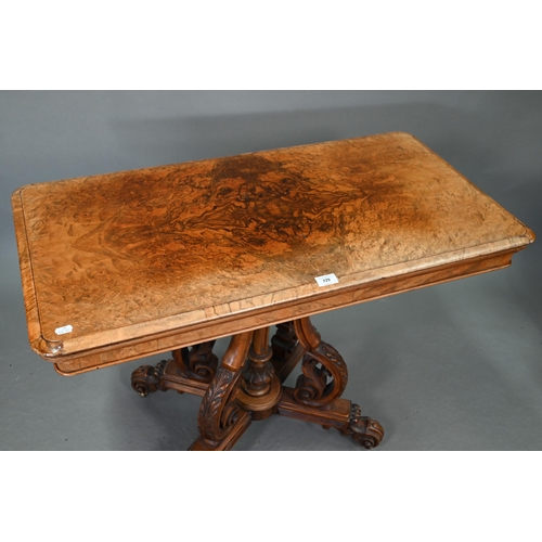 729 - A Victorian figured walnut card table, the rectangular fold over top enclosing a baize lined interio... 