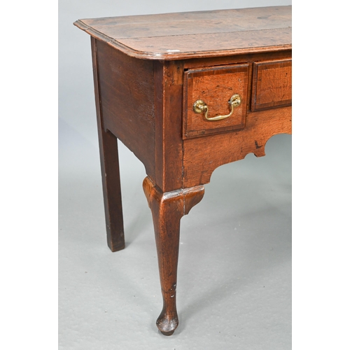 730 - An 18th century oak three drawer lowboy within a shaped apron, raised on cabriole legs to pad feet, ... 