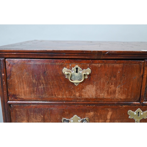 731 - An 18th century feather-banded walnut chest of two short over three long graduated drawers, with bra... 