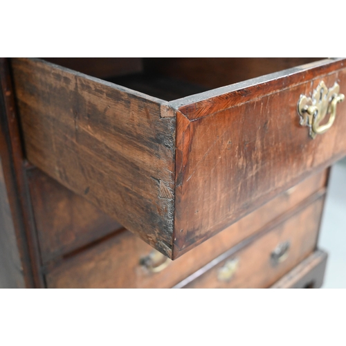 731 - An 18th century feather-banded walnut chest of two short over three long graduated drawers, with bra... 