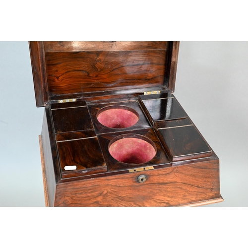 738 - A Regency rosewood sarcophagus form teapoy, the interior with four lidded tea boxes, centred by two ... 