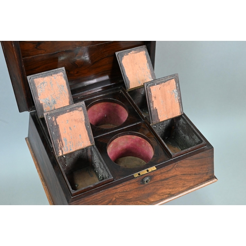738 - A Regency rosewood sarcophagus form teapoy, the interior with four lidded tea boxes, centred by two ... 