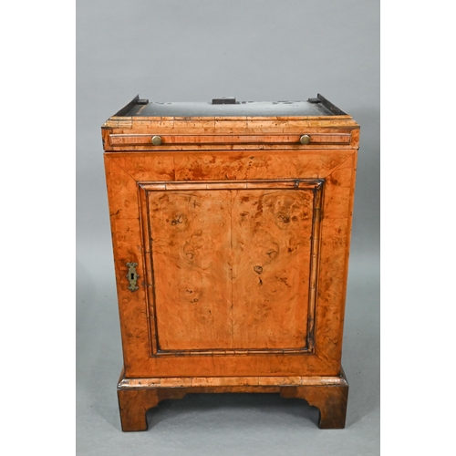 739 - An antique William & Mary style walnut cabinet, in two sections, the shaped canopy over a mirror... 