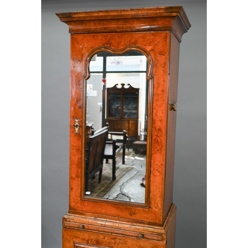 739 - An antique William & Mary style walnut cabinet, in two sections, the shaped canopy over a mirror... 