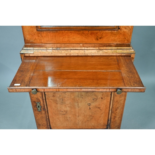 739 - An antique William & Mary style walnut cabinet, in two sections, the shaped canopy over a mirror... 