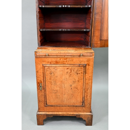 739 - An antique William & Mary style walnut cabinet, in two sections, the shaped canopy over a mirror... 