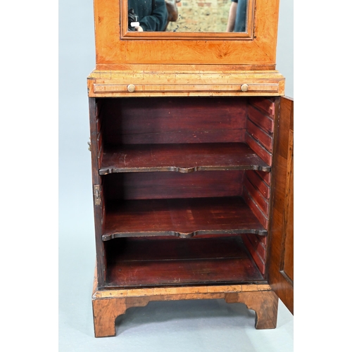 739 - An antique William & Mary style walnut cabinet, in two sections, the shaped canopy over a mirror... 