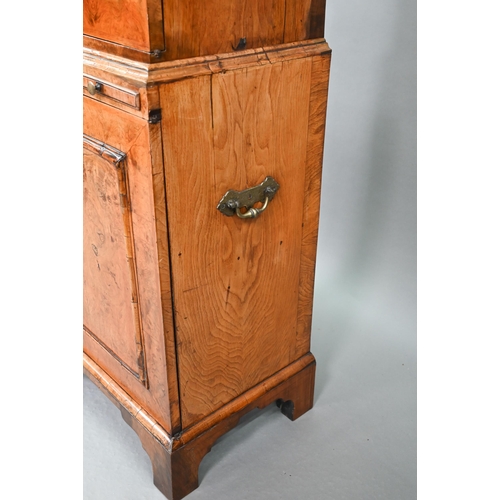 739 - An antique William & Mary style walnut cabinet, in two sections, the shaped canopy over a mirror... 