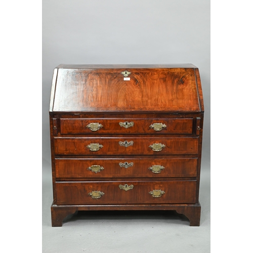 742 - An 18th century feather banded walnut bureau, the fitted interior centred by a cupboard over four lo... 
