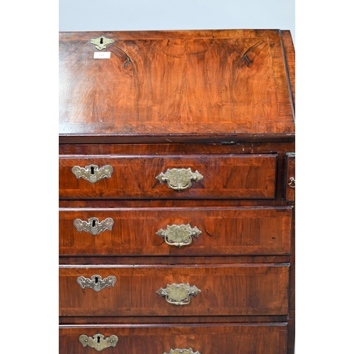 742 - An 18th century feather banded walnut bureau, the fitted interior centred by a cupboard over four lo... 