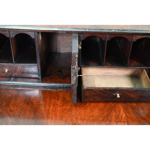 742 - An 18th century feather banded walnut bureau, the fitted interior centred by a cupboard over four lo... 