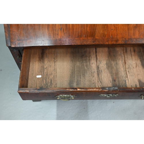742 - An 18th century feather banded walnut bureau, the fitted interior centred by a cupboard over four lo... 